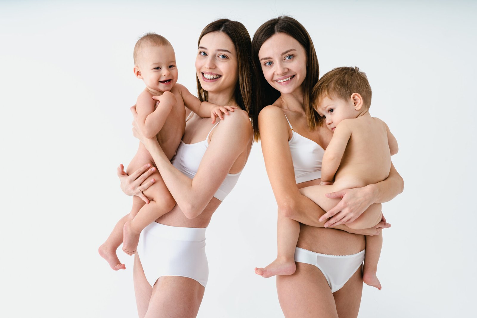 Beautiful women holding baby boys, motherhood and pregnancy conc Beautiful women holding baby boys, motherhood and pregnancy conc